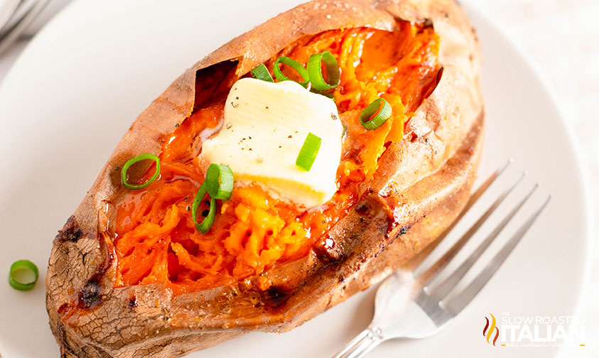 baked sweet potato on a plate with a fork