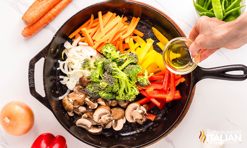 adding veggies to cast iron skillet