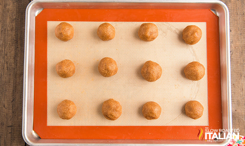 keto peanut butter cookie dough rolled into balls on a baking sheet