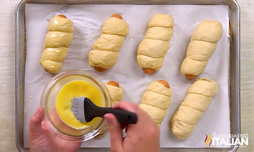 brushing pretzel dogs with egg wash