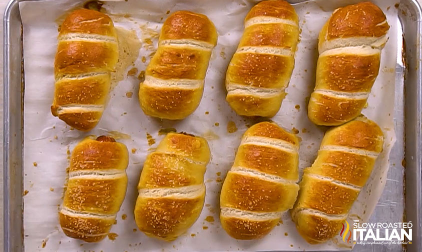 baked pretzel dogs on baking sheet