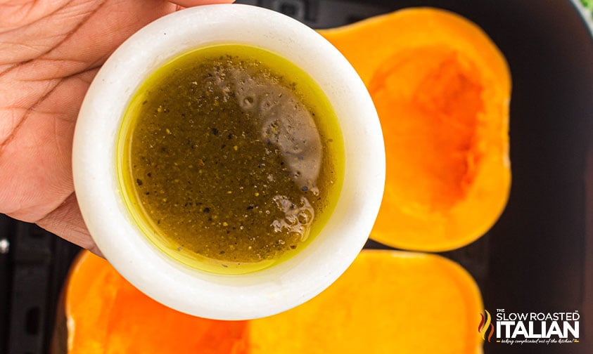 adding butter and seasonings to butternut squash