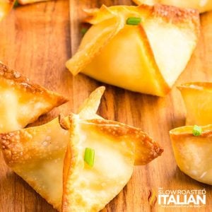 air fryer cream cheese wontons on a wooden board