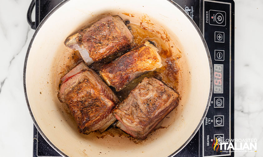 browned beef short ribs in a large dutch oven