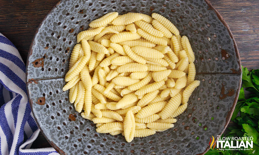 homemade cavatelli pasta in metal strainer