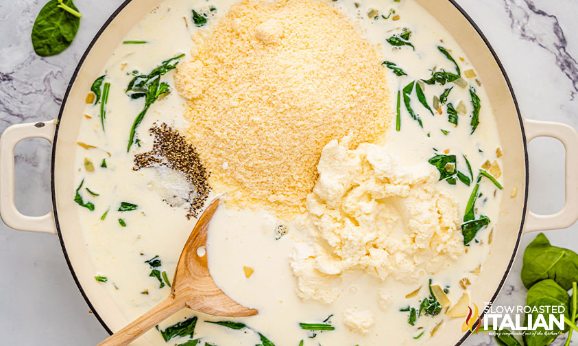 adding chicken alfredo lasagna ingredients to pot