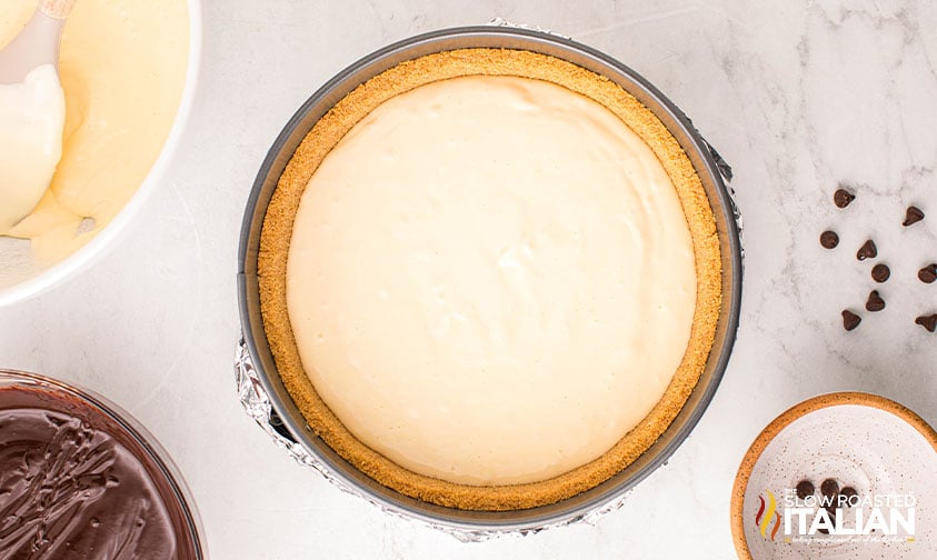 cheesecake mixture poured into graham cracker crust