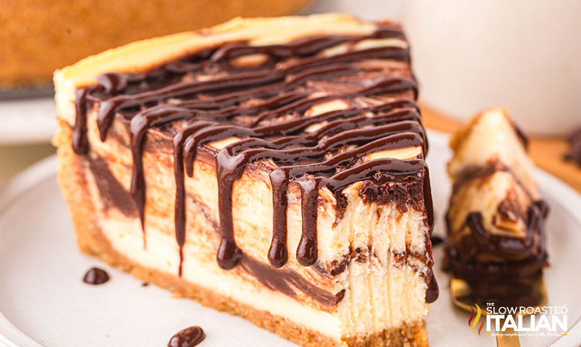 closeup of a slice of chocolate swirl cheesecake on a plate