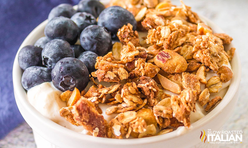 air fryer granola in a bowl with yogurt and blueberries