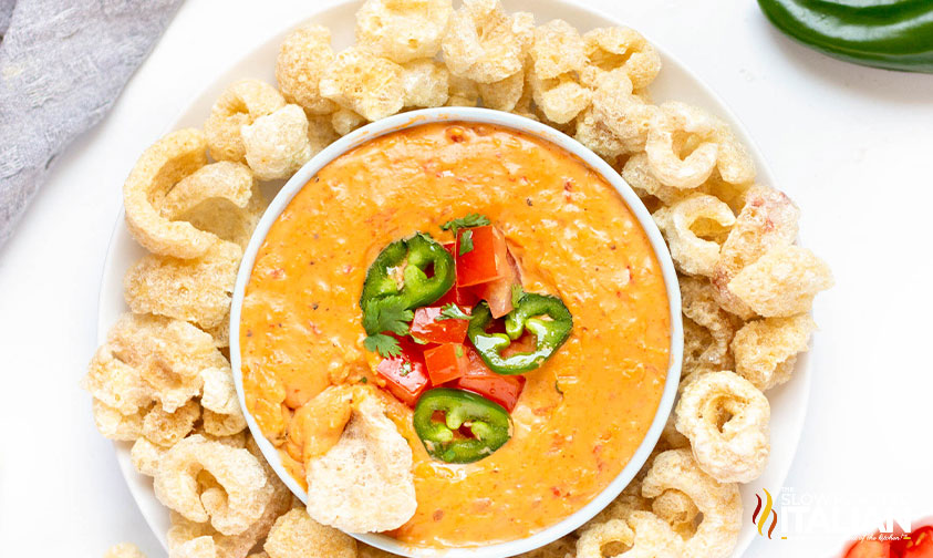 bowl of keto queso surrounded with pork rinds