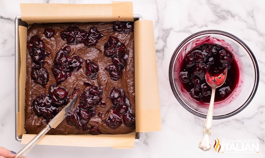 adding cherry mixture to brownie batter