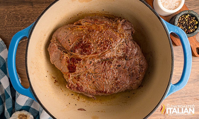 seared chuck roast in a dutch oven