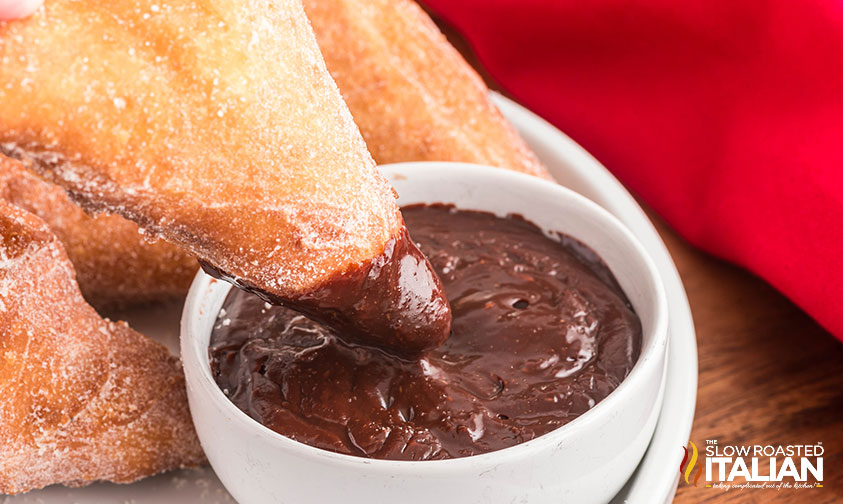 dipping olive garden italian donut in chocolate sauce