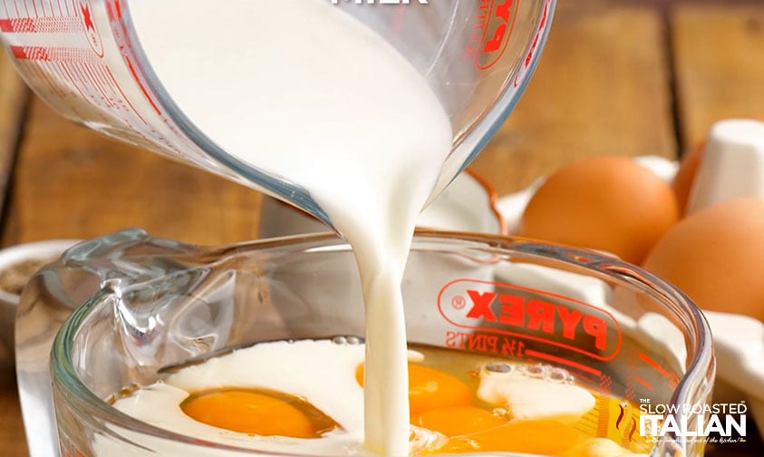 combining eggs and milk in a large measuring cup