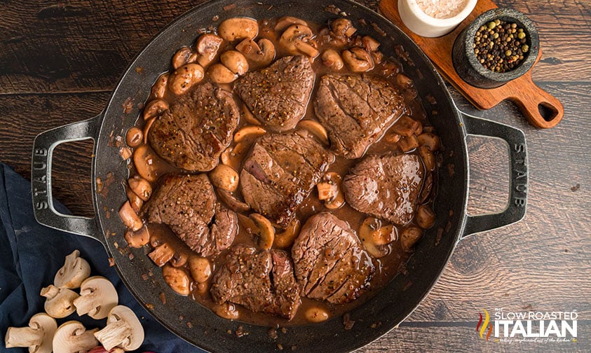 steaks added back to cast iron pan