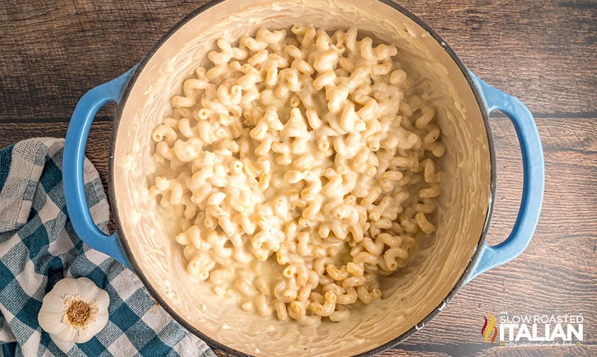 adding cooked pasta to pot