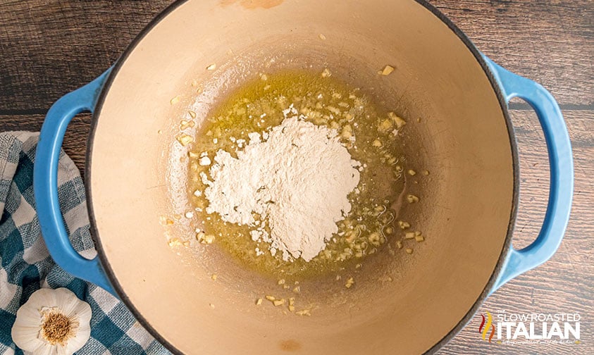 adding flour to melted butter and garlic