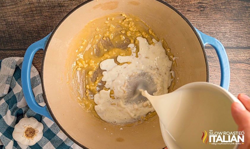 adding heavy cream and milk to pot