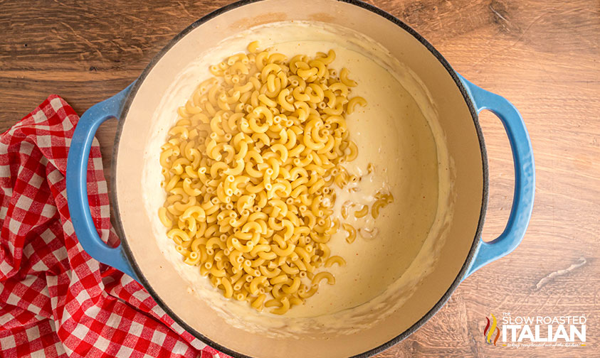 cooked elbow macaroni added to cheese sauce