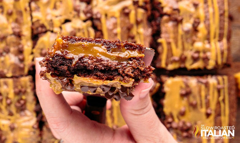 hand holding a salted caramel fudge brownie