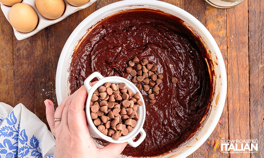 adding chocolate chips to brownie mix