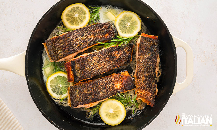 flipped salmon in cast iron skillet