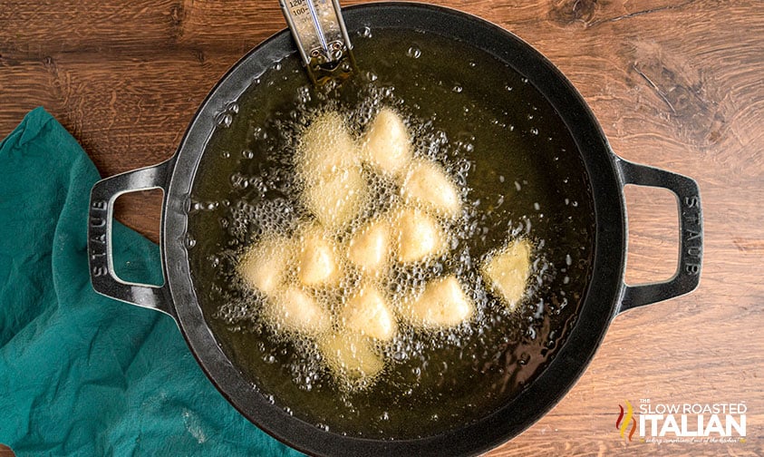 frying biscuit dough in a skillet