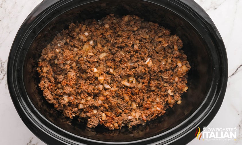 ground beef and onion mixture added to slow cooker