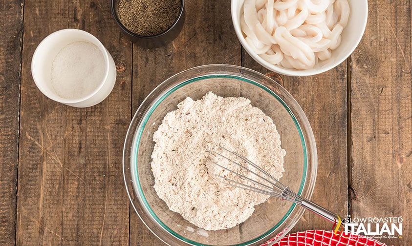 mixing flour and seasonings in a large bowl