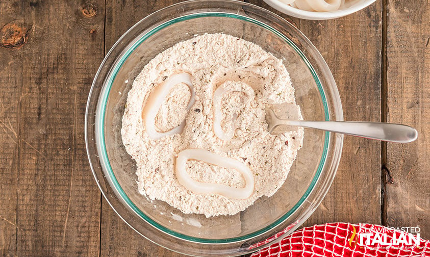 calamari rings dredged in flour and seasoning mixture