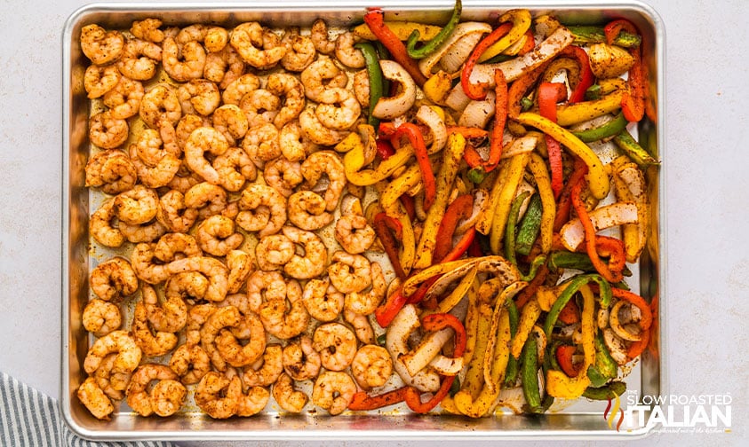 baked shrimp and veggies on a baking sheet