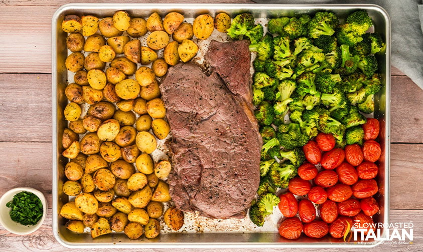 sheet pan steak dinner baked on a baking sheet