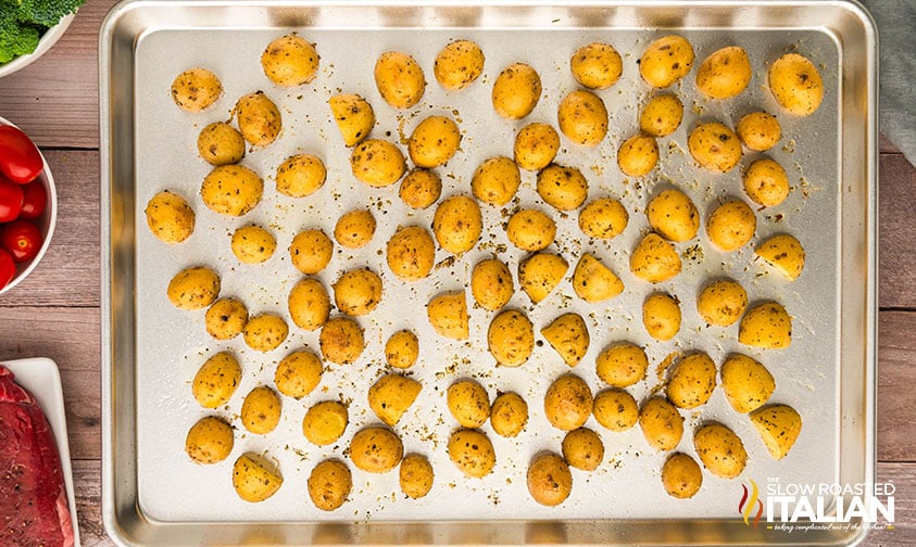 placing potatoes on a baking sheet