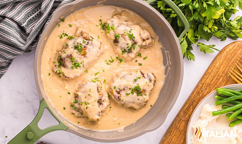 smothered chicken in a large skillet