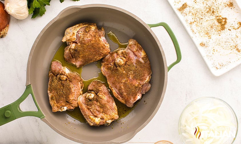 searing chicken thighs in a skillet