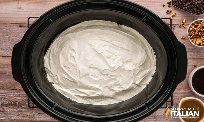 adding whipped topping to cooled cake