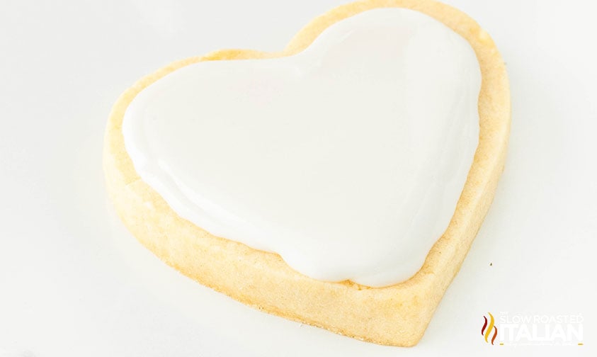 white icing on a heart sugar cookie