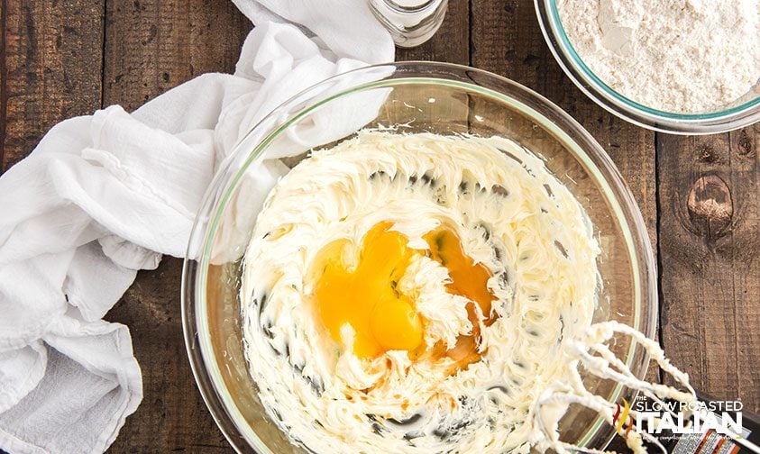 eggs and vanilla in bowl of creamed butter and sugar