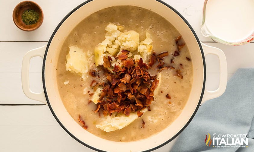 adding crumbled bacon to large pot