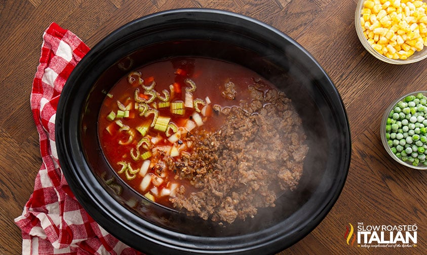 adding sausage and veggies to crock pot