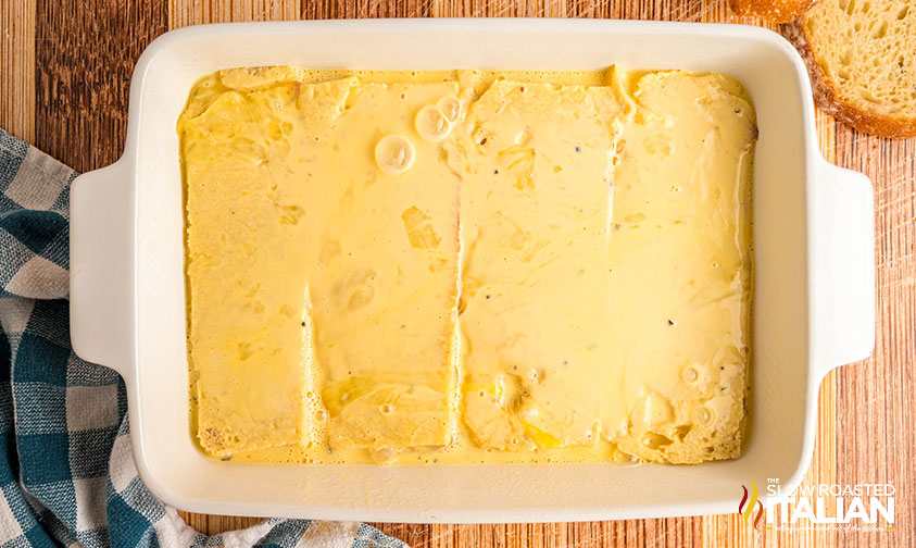 egg mixture poured over bread in casserole dish