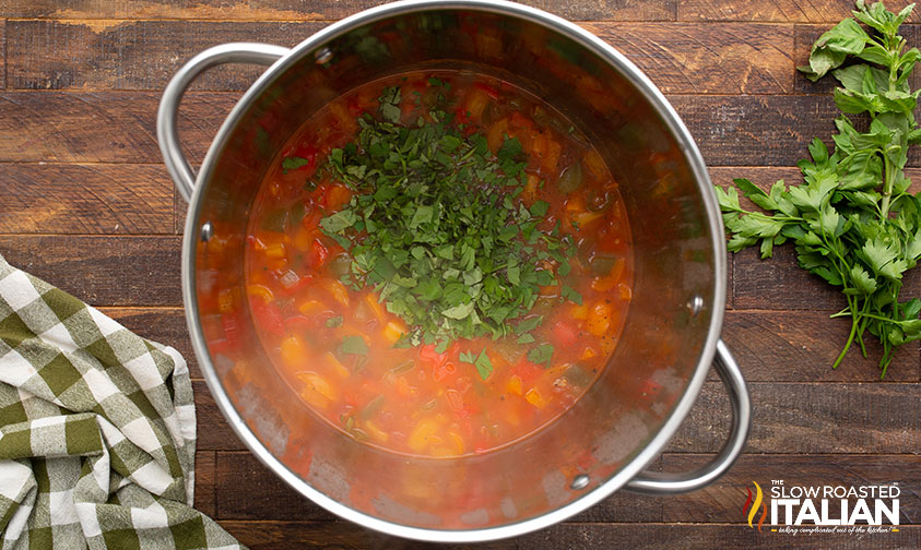 adding tomatoes, broth, and tomato paste to pot