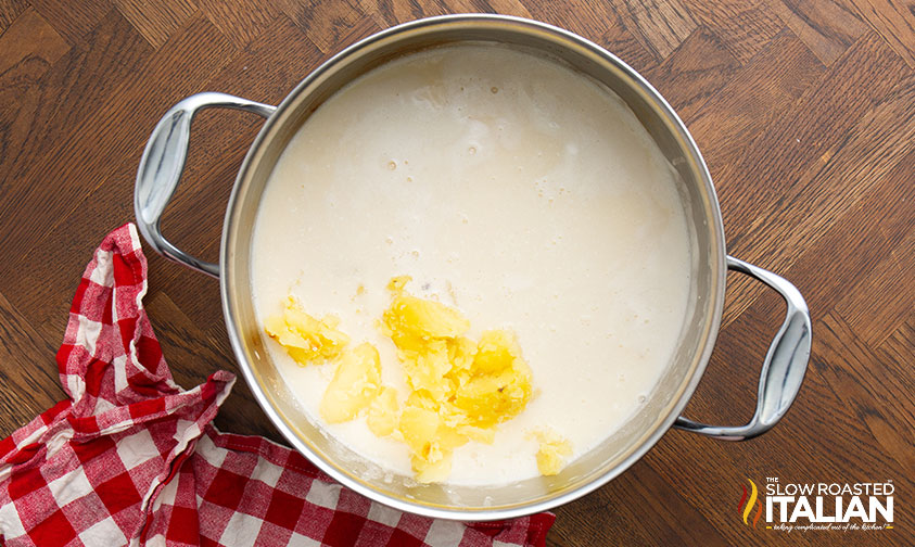 adding potatoes to large pot