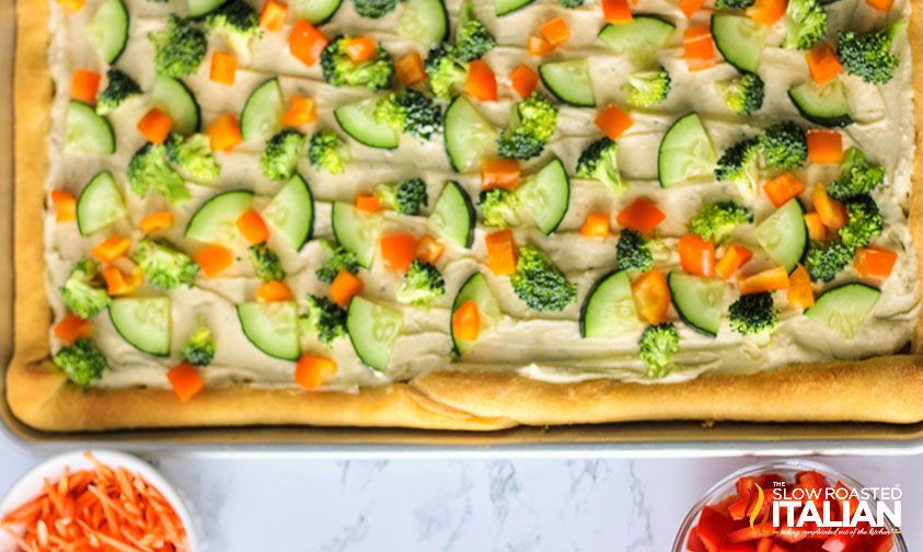 cucumber, broccoli, and carrots on a veggie pizza