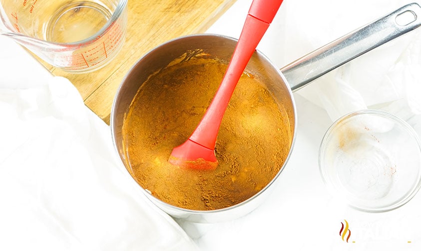 simmering ingredients for maple glazed ham in a small pan