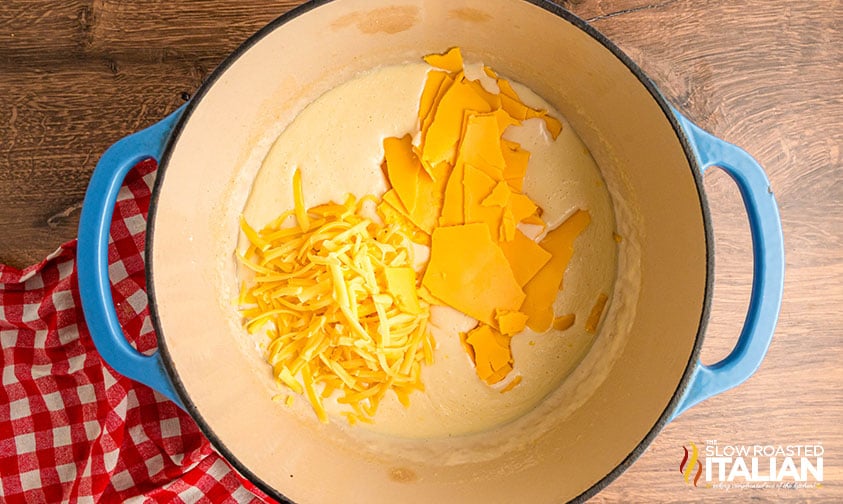 shredded and sliced cheese added to large pot