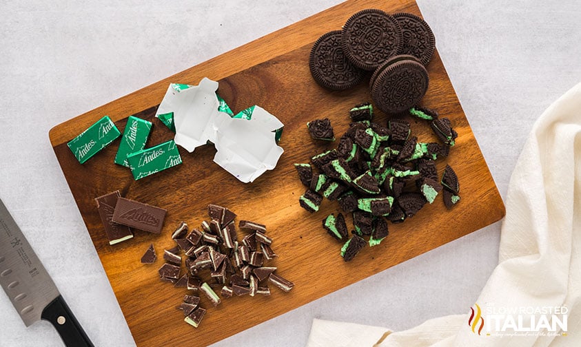 chopped oreos and andes mint candies on a cutting board