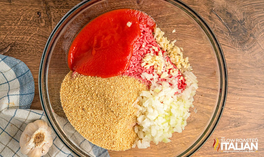 combined ground beef, breadcrumbs, onion, garlic, and tomato puree in a large bowl