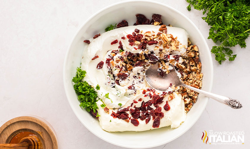 mixing goat cheese balls ingredients in a mixing bowl