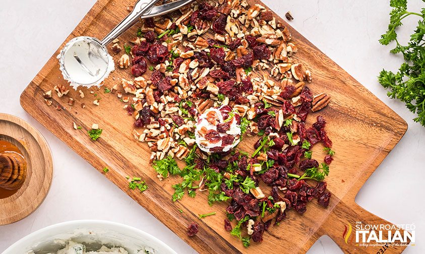 rolling goat cheese balls in toppings